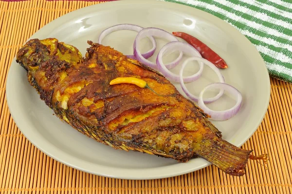 Fried fish decorated with onion rings