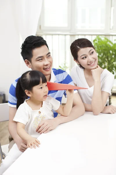 Family palying paper airplane