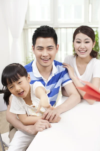 Family palying paper airplane