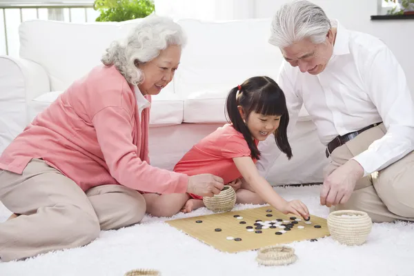 Couple with granddaughter playing