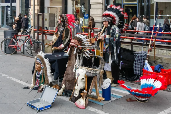 Buskers dressed as american red indians making music in Milan