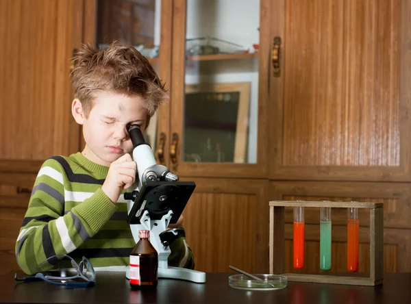 Little boy making science experiments. Education.