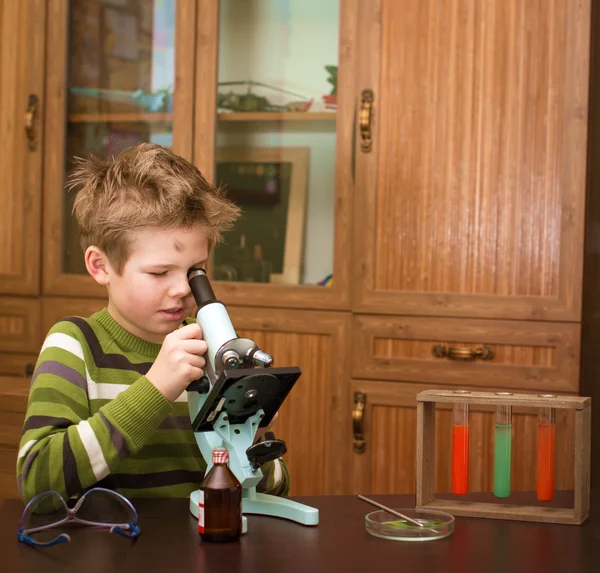 Little boy making science experiments. Education.