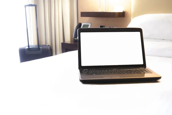 Hotel bed with laptop