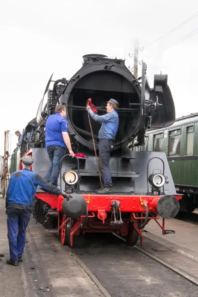Editorial use only. Maintenance on a historic steam train.