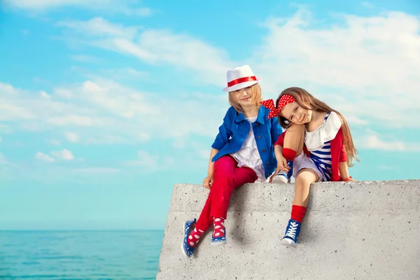 Fashion kids resting on the sea