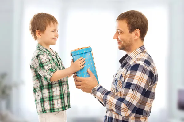 Happy son gives his father gift