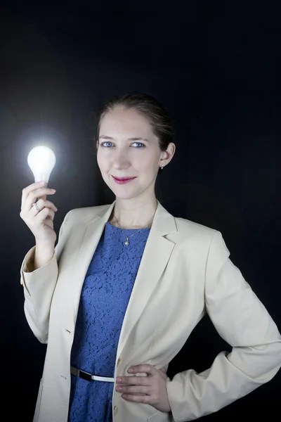 Business woman holding light bulb