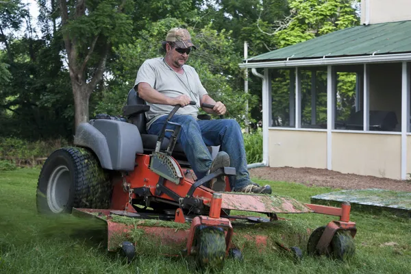 Landscaper on riding lawn mower