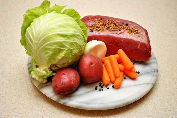 Ingredients for a Boiled Corned Beef Dinner on a Marble Cutting Board