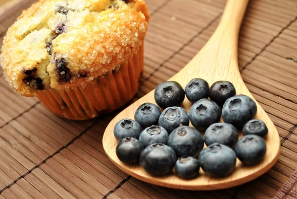 Blueberries Next to a Blueberry Muffin