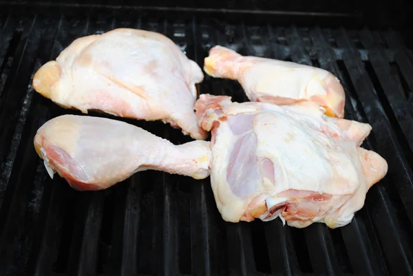 Raw Chicken Legs and Thighs on the Grill