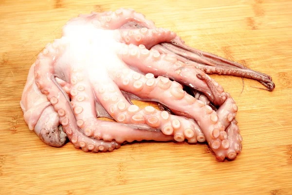 Whole Raw Octopus on a Wooden Cutting Board