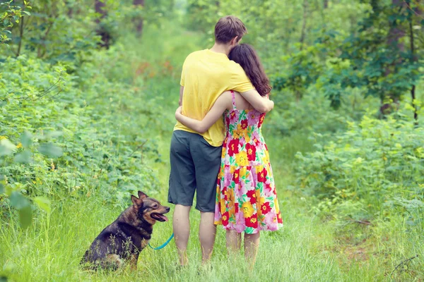 Couple in forest with dog