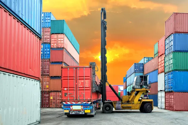 Forklift handling container box loading to truck in import expor