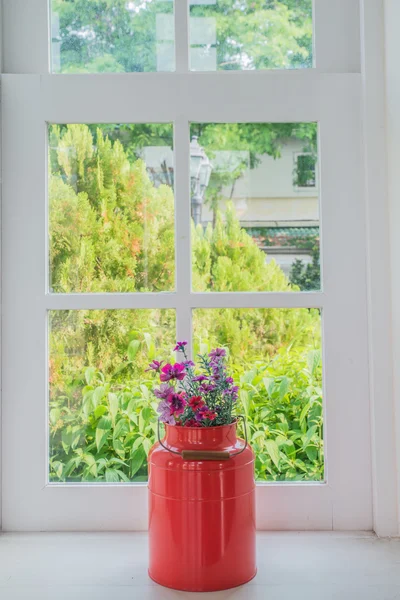Jug of fresh summer flowers on a window sill