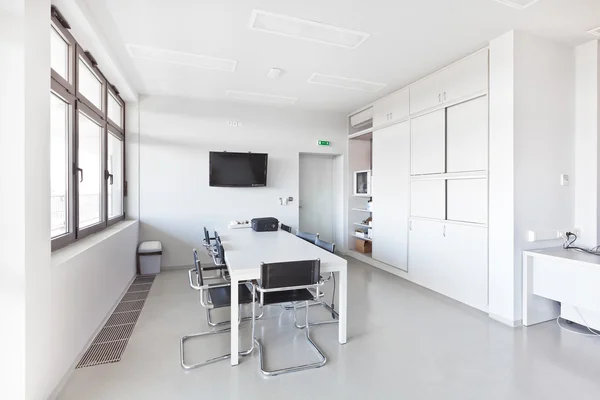 Modern office with white furniture, cupboard, conference desk an