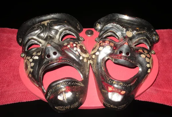Happy-and-unhappy-theatre-masks-painted-stained-on-a-red-background