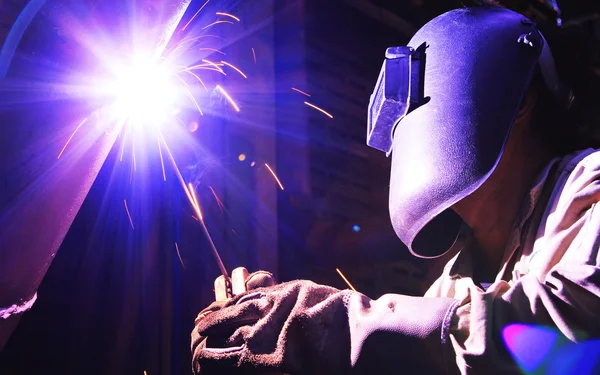 Industrial worker make a spark welding