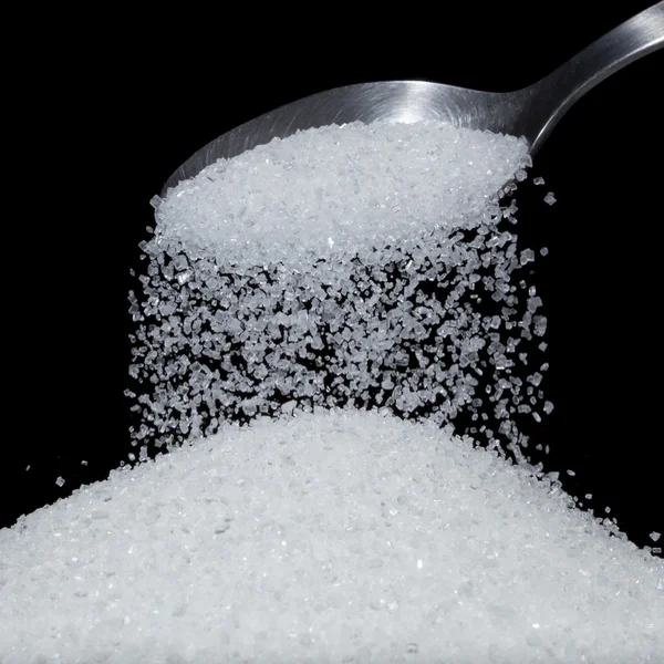 Sugar poured from spoon