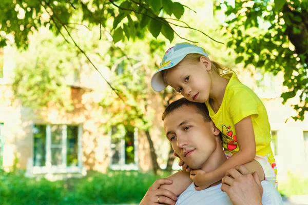 Dad with his daughter during the summer stroll