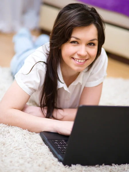 Young woman is playing on laptop