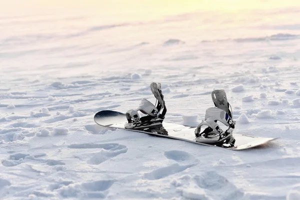 Snowboarding in the snow at sunset