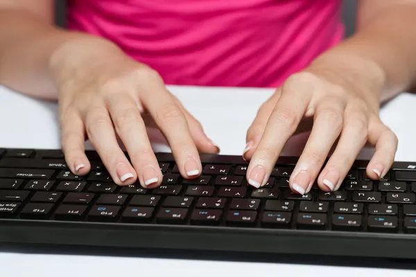 Woman Typing On A Black Keyboard