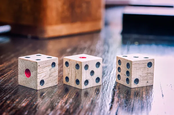 Wooden dices on on a old wood  floor