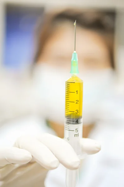 Doctor using a syringe