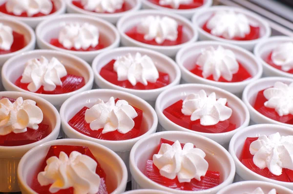 Sweet cold red jelly and whipped cream