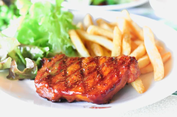 Pork loin steak in a dish Serve with French fries