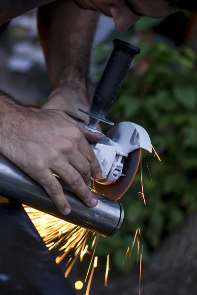 Man workin with iron, sparks