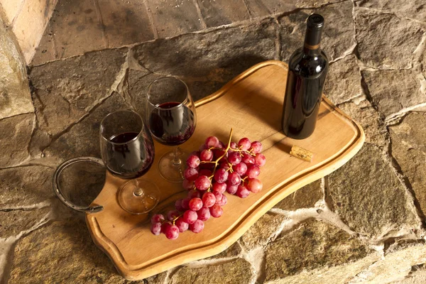 Wine cups, cork, bottle of wine, grapes