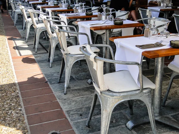 Row of aluminium chairs and tables from a restaurant