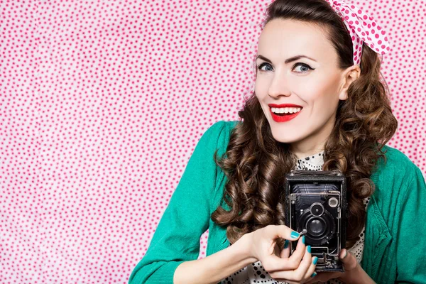 Beautiful happy woman with old camera