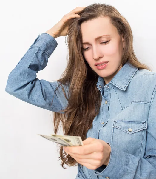 Stressed young woman holding money