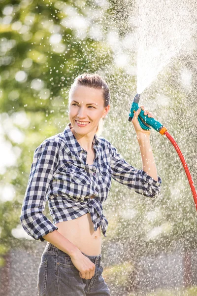 Cheerful woman watering