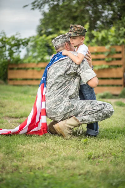 Father hugs his son. American family