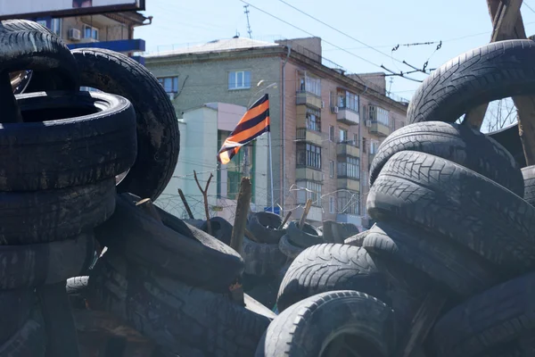 Pro-Russian separatist flag over the barricades near the captured building SBU Lugansk, Ukraine