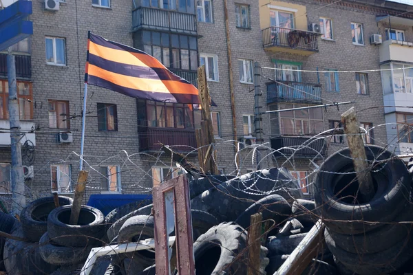 Pro-Russian separatist flag over the barricades near the captured building SBU Lugansk, Ukraine