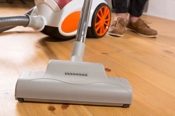 Cleaning with vacuum cleaner in living room