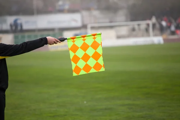 Soccer referee hold the flag. Offside trap