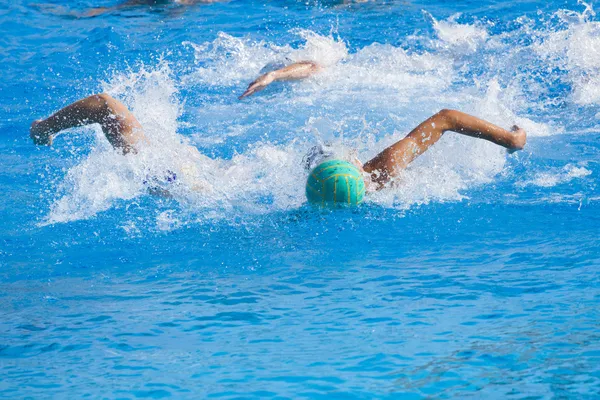 Water polo action in a swimming pool