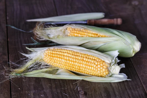 Sweet corns on dark rustic wooden background