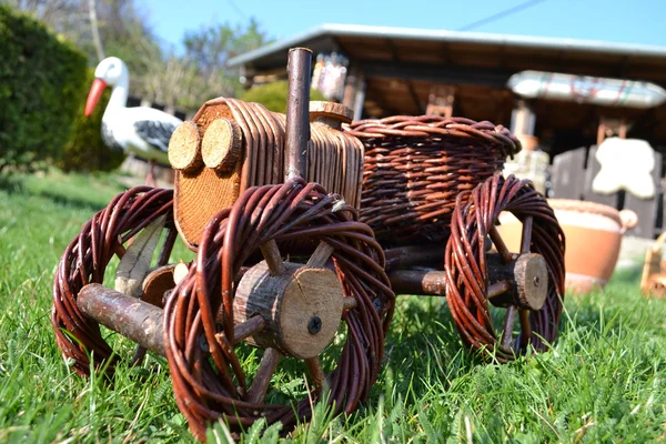 Model tractor wicker and wood on a green grass