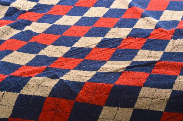 Checkered blue and red fragment of wrinkled cloth as a backgroun