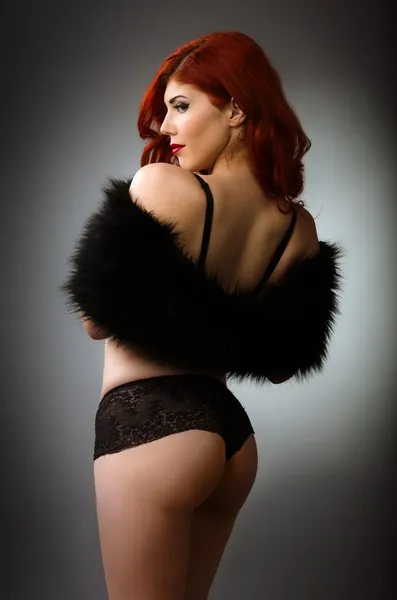 Sexy redhead woman in black lingerie