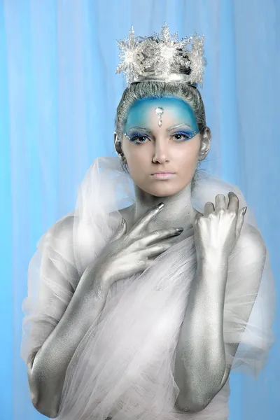 Model with artistic make up posing as Ice Queen or Snow Fairy