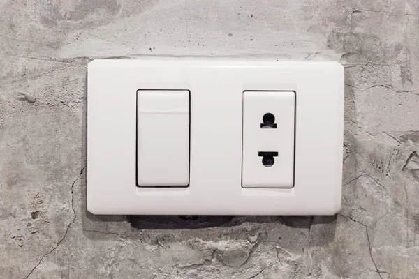 Light white switches on concrete wall
